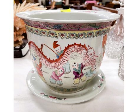 A Chinese Republic period shallow bowl decorated in polychrome with children exercising, orange seal to base, diameter 21cm; 