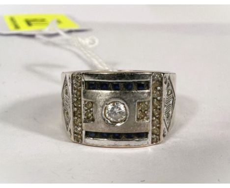 A white yellow gold ring stamped '750' set with clear stones with incised decoration to each side size U weight 12.4gms 