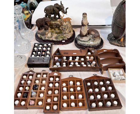 A selection of collectable ceramic thimbles and two resin groups of animals 