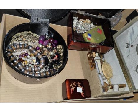 A vanity case filled; a lacquer box and a circular box with costume jewellery&nbsp; 