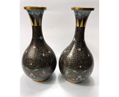 A pair of late 19th/ early 20th century cloisonne vases, black ground with coloured and gilt decoration, height 22cm One vase