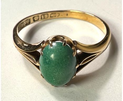 An 18ct hallmarked gold ring set with an oval cabochon Jade coloured stone, 3gm, size 'O' 