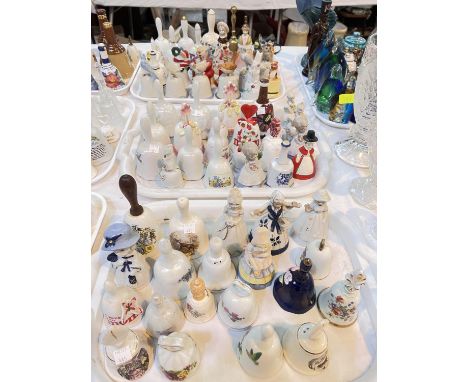 A large selection of ceramic and other bells with animal finials etc 