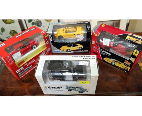 A Haynes Land Rover Build your own car 1:24 scale, boxed, three similar car building sets in boxes at various stages of compl