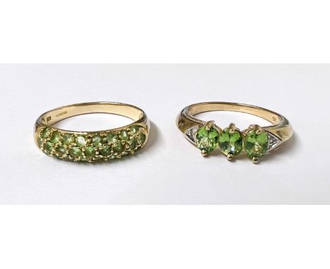 A 9ct hallmarked gold ring set 3 oval peridots size N; a 9ct hallmarked ring set with 3 bands of peridots size R gross weight