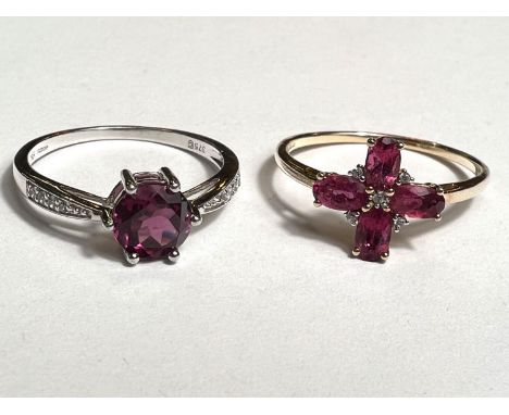 A 9ct hallmarked ring set with 4 oval pink stones interspersed with clear stones size P/Q and a 9ct hallmarked white gold rin