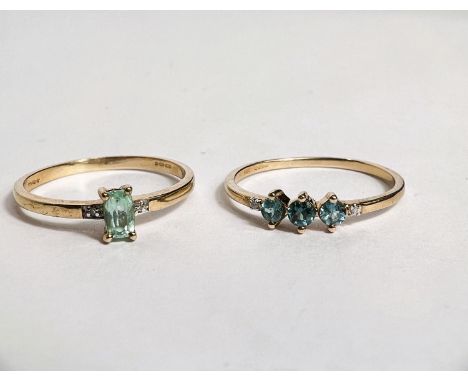 A hallmarked gold dress ring, stamped '10ct', set 3 aquamarine colour stones and small clear sapphire chip to each shoulder, 