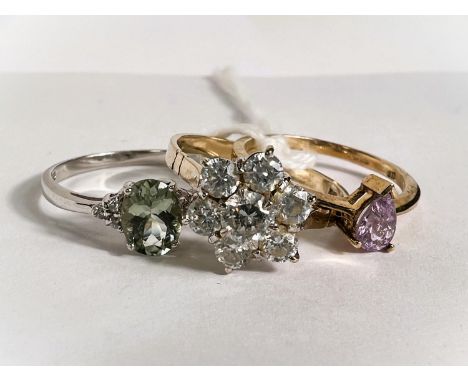 A hallmarked white gold ring with aquamarine coloured central stone and 3 clear stone chips to each shoulder; a 9ct hallmarke
