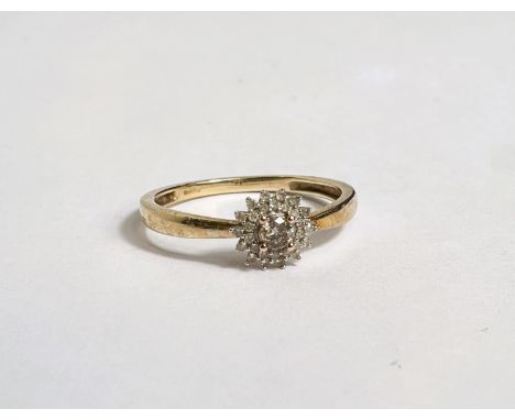 A lady's 9 carat gold dress ring set central champagne diamond, surrounded by small white diamonds in flower design, size R/S