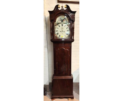 An early 19th century figured mahogany long cased clock, the hood with swan neck pediment and turned side columns, arched doo