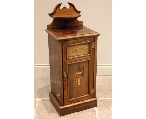 An Edwardian rosewood pedestal bedside cupboard, by Thomas Edwards &amp; Sons, the shaped pediment with bowfront shelf over a