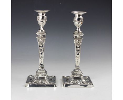 A pair of Victorian silver candlesticks, William Hutton & Sons, London 1892, the urn shaped sconce above tapered stem decorat