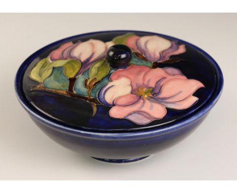 A Moorcroft footed bowl and cover in the 'Magnolia' pattern by Emma Bossons, early 21st century, the cobalt blue shallow bowl