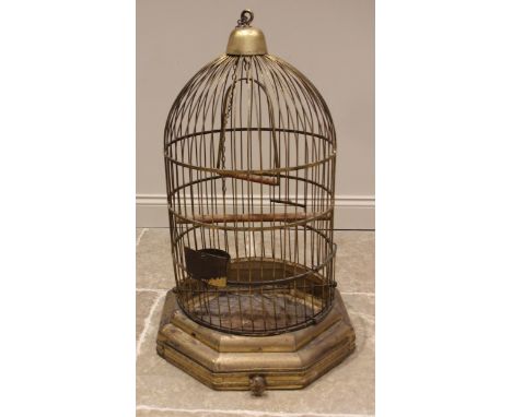 A Victorian patinated brass parrot/bird cage, of typical domed form, fitted with a swing, perch, feeding trough and sliding d