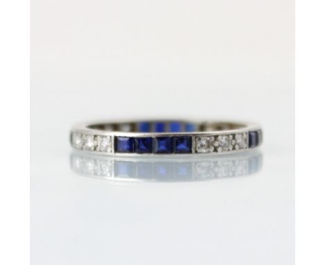 An Art Deco diamond and untested sapphire full eternity ring, the three round cut diamonds with four calibre cut untested sap