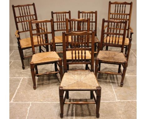 A matched set of eight ash Lancashire spindle back, rush seated kitchen chairs, 19th century, to include two carver chairs, a