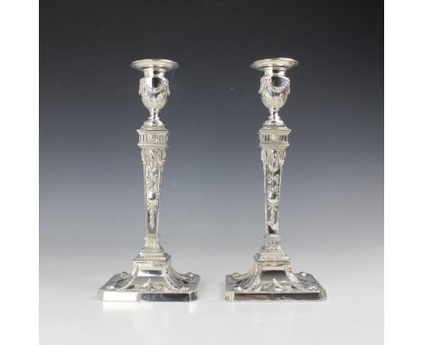A pair of Edwardian silver candlesticks, William Hutton & Sons Ltd, London 1902, the urn shaped sconce above tapered stem dec