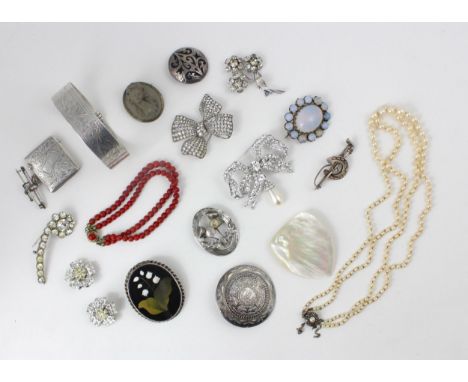 A large selection of costume jewellery, including string of paste pearls, paste set brooches, silver bangle, 'WH' London 1947