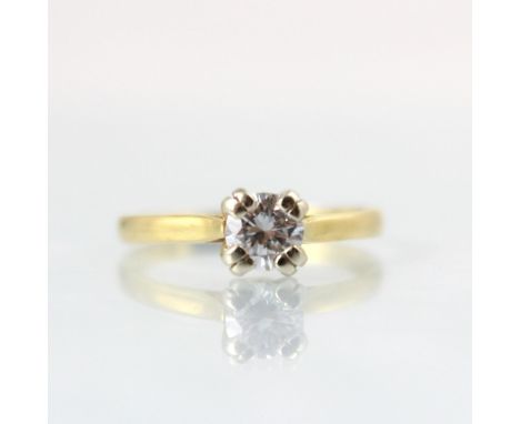 An Edwardian style diamond solitaire ring, the round cut diamond within four double claw setting edge, leading to plain polis