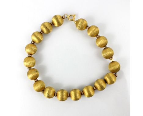 A yellow metal trace link bracelet, the bracelet with eighteen spherical beads with gilt engraved decoration, bolt ring stamp