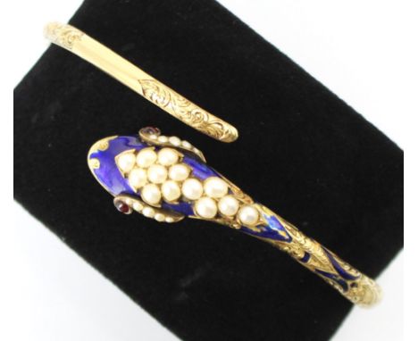 A Victorian enamel and untested pearl snake bangle, the double hinged bangle designed as a coiled serpent, the head decorated
