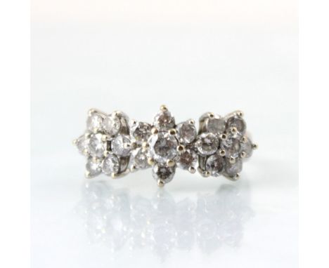 A 18ct white gold diamond triple cluster ring, the central round cut diamond within surround of six smaller round cut diamond