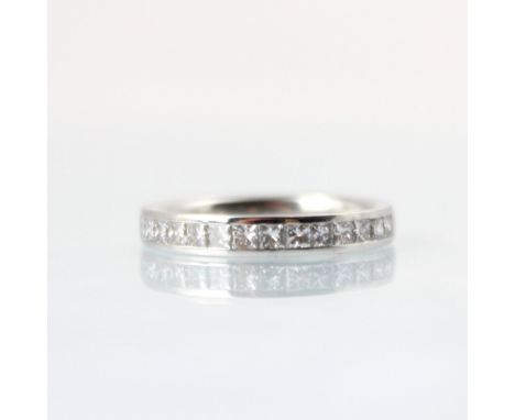 A diamond half eternity ring, the fourteen princess cut diamonds channel set in white metal, with plain polished shank, ring 