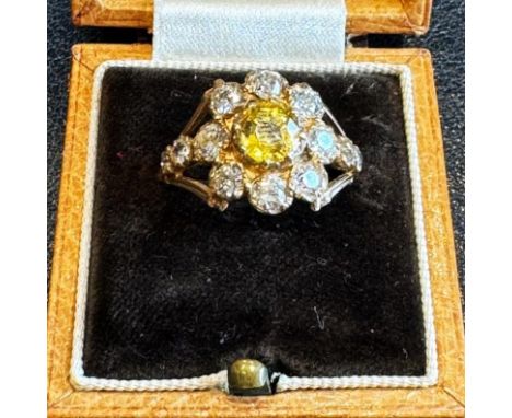 A late 19th century style yellow sapphire and diamond cluster ring, the central cushion cut yellow sapphire within a surround