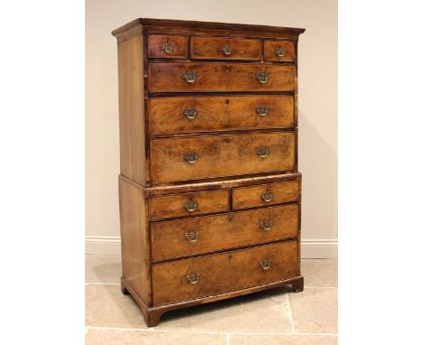 A George I walnut chest on chest, the moulded pediment over an arrangement of three short and three long cross banded drawers