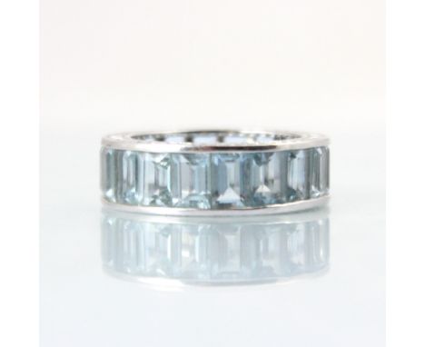 A late 20th century untested aquamarine full eternity ring, the eighteen rectangular cut blue stones channel set in white met