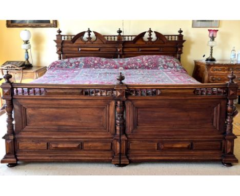 A French walnut super king-size bed, early 20th century, constructed as two single beds, the headboard with architectural ped