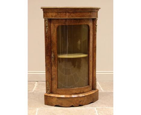 A Victorian burr walnut freestanding corner cabinet, of bowfront form, applied with gilt metal banding and mounts, the single