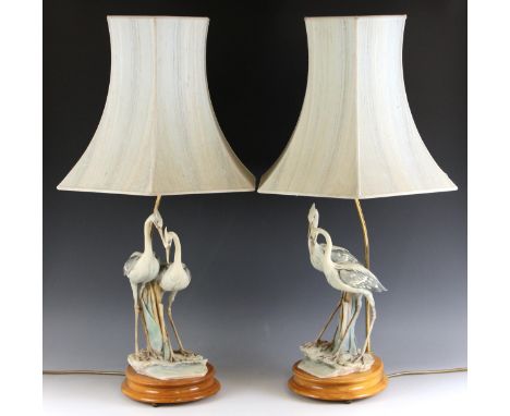 A pair of Capodimonte table lamp bases, each modelled as a pair of herons, impressed and painted maker's marks, each 51cm hig