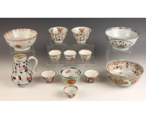 A pair of Chinese porcelain famille verte tea bowls, Kangxi (1662-1722), each of fluted circular form and externally decorate
