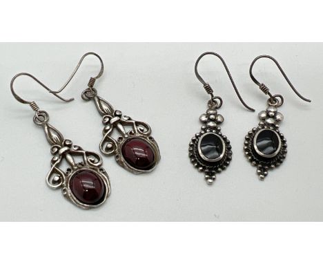 2 pairs of drop style stone set earrings with hooked posts. One in an Art Nouveau style set with garnet cabochons the other w