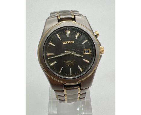 A Seiko 5M62-OAMO kinetic Titanium wristwatch with black face and gold tone hands. Hour markers with luminous detail. Has sec