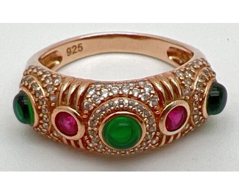 A silver gilt multi-coloured stone half eternity style dress ring. Set with green cabochon stones, small round cut clear ston