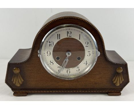 A vintage dark oak cased striking mantel clock with embossed beading and detail to front. Complete with pendulum and key. Win