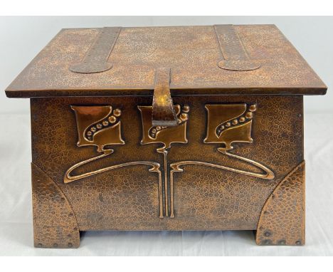 An Arts &amp; Crafts copper coal box with hammered design, complete with liner. Decorated with stylised Art Nouveau floral de