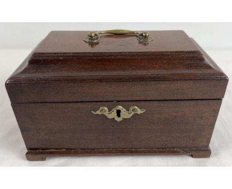 A vintage mahogany tea caddy with 2 interior lidded compartments. Metal swing handle and decorative escutcheon. 2 pieces of b