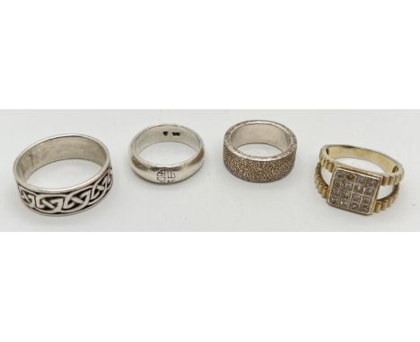 4 silver rings. One with square mount set with small round clear stones, other 3 in a band style all with varying decoration.