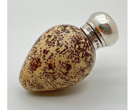 A Victorian novelty scent bottle modelled as a bird egg, with hallmarked silver lid. Porcelain light brown and black speckled