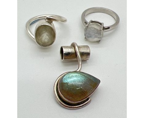 3 pieces of modern design semi precious stone set silver jewellery. A dress ring set with a faceted moonstone, a dress ring i