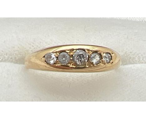 An Edwardian 18ct gold and diamond engagement ring. Band style set with 5 graduating size round cut diamonds. Total diamonds 