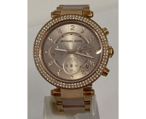 A Michael Kors "Parker" ladies chronograph wrist watch in rose gold finish with blush pink links. Date function, seconds hand
