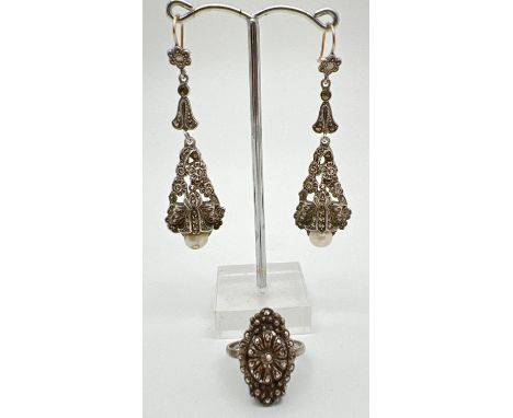 A pair of vintage white metal, floral design, drop style earrings, together with a similar dress ring. Earrings set with marc