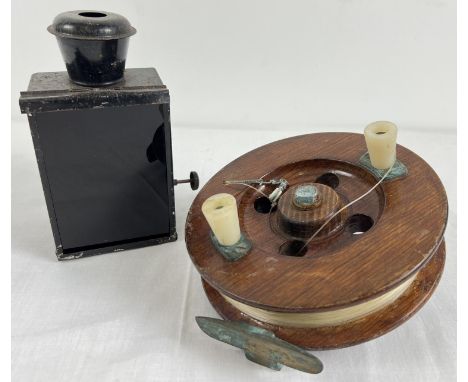 A large antique wooden fishing reel together with a vintage black metal paraffin lantern with red glass shade (approx. 18cm t