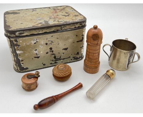 A small tin containing a small collection of vintage items to include a treen screw top perfume bottle holder in the shape of