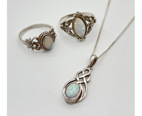 3 pieces of opal set silver and white metal jewellery. 2 decorative dress rings and a Celtic style pendant on an 18 inch fine