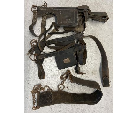A collection of vintage heavy horse leather straps and harness to include Blinkers/blinders. 